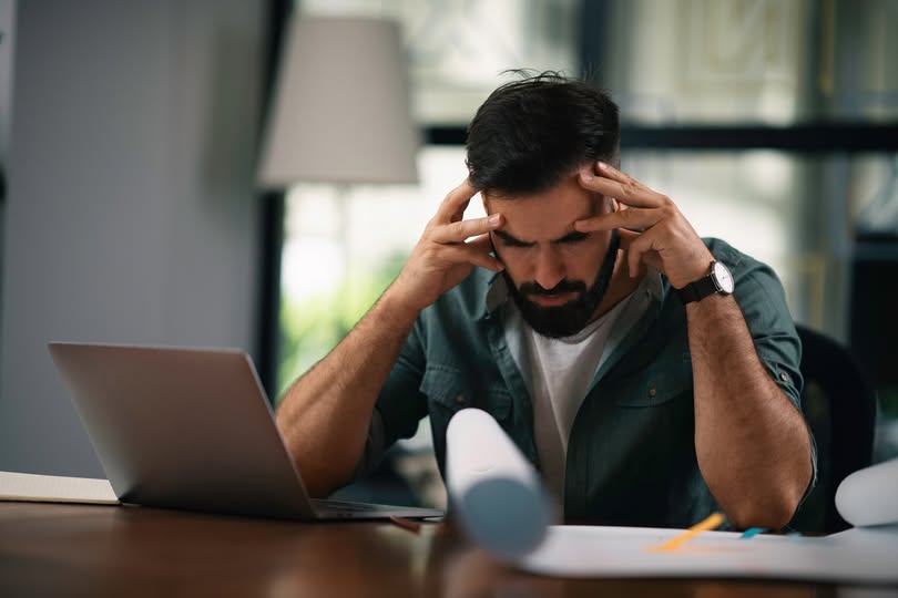 worried man looking at his finances