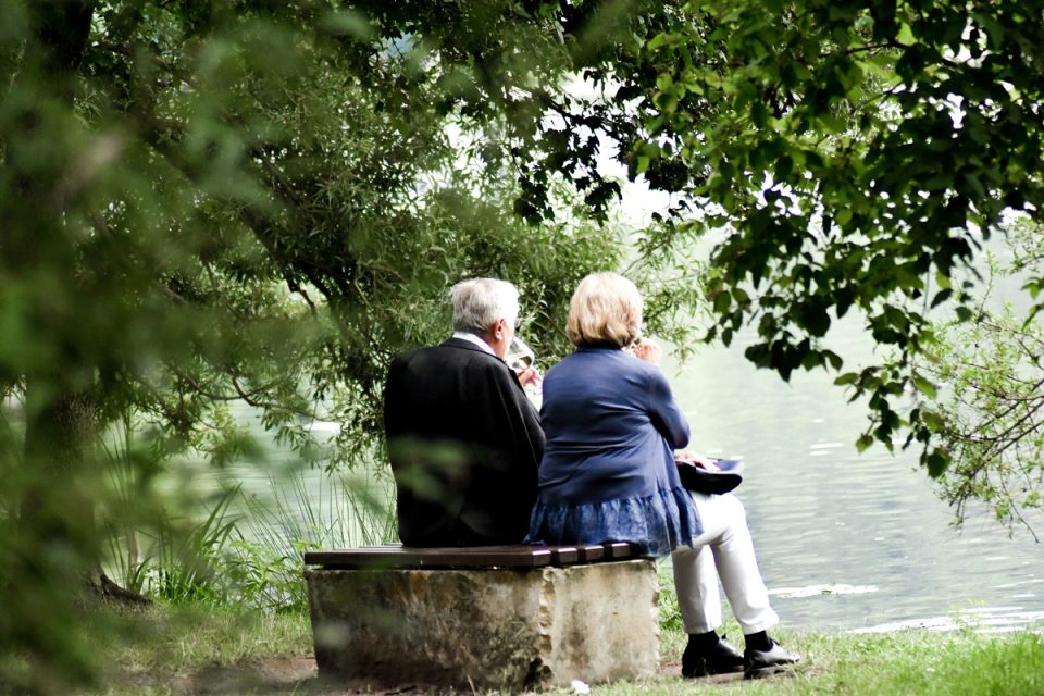 older couple picnic at the lake